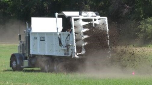 manure spreader operating in a field