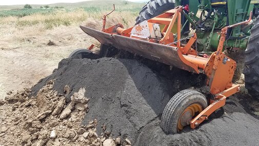 Figure 1. Coal combustion residue is being mixed into manure for land application.