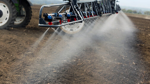tractor spraying nitrogen on field