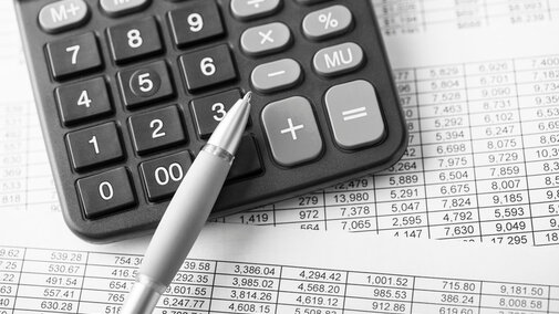 Calculator with financial papers