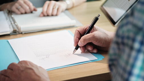 people signing legal documents