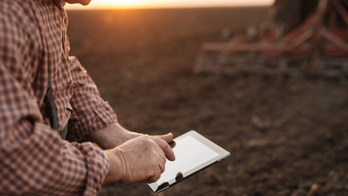 man using tablet in field