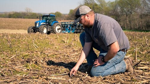 A farmer inspecting soil