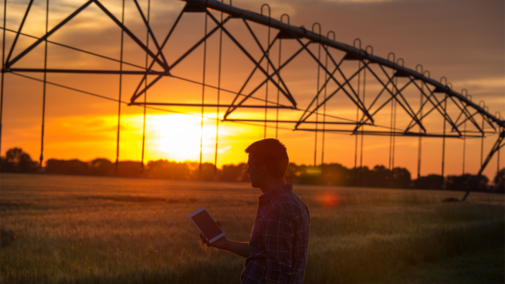 Farmer with tablet near pivot