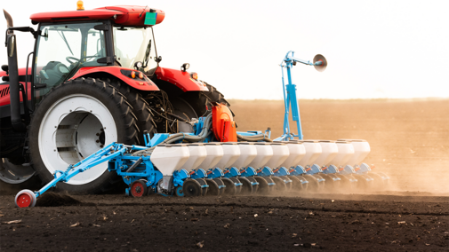 Tractor planting wheat in field