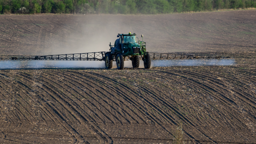 Tractor spraying soil