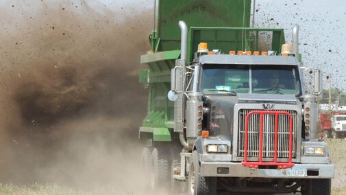 Truck spreader applying manure to field