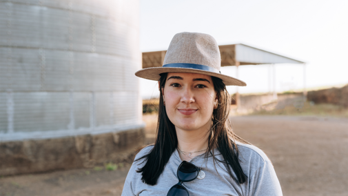 Woman farmer near grain bin