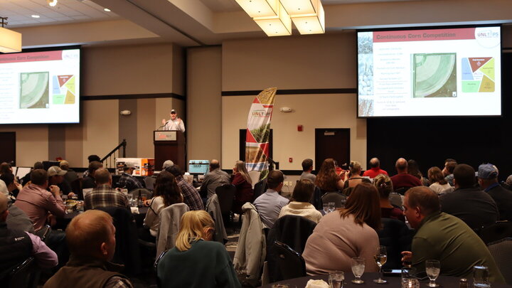 people seated at tables during presentation