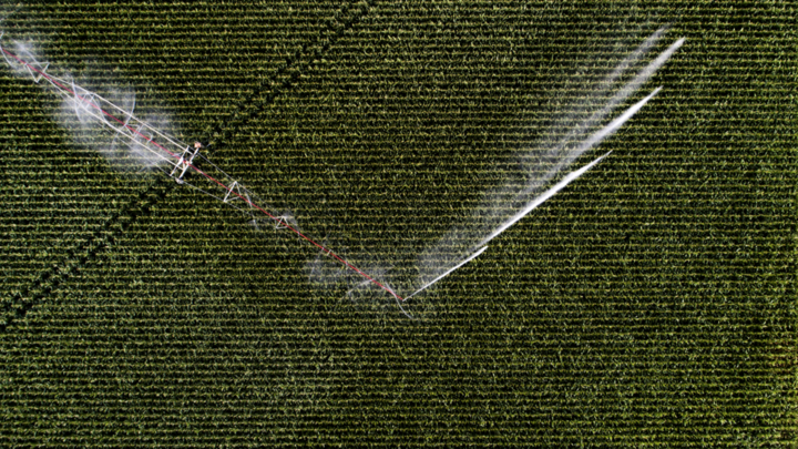 aerial view of center pivot running in field