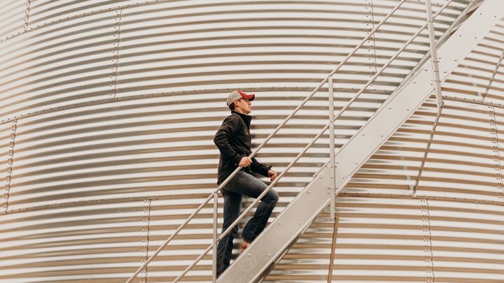 man climbing stairs of grain bin