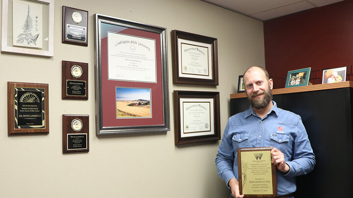 man holds plaque