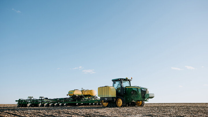 tractor pulling seeder in field