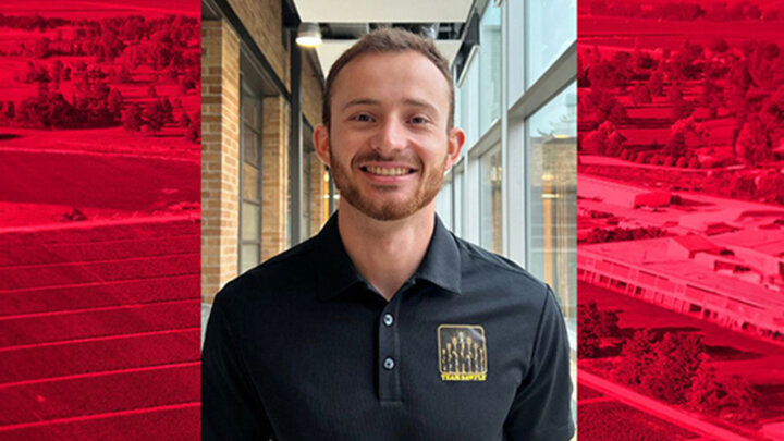 Vinicius Zuppa, UNL Extension Educator, smiling in a hallway while wearing a black Team Beans polo shirt.