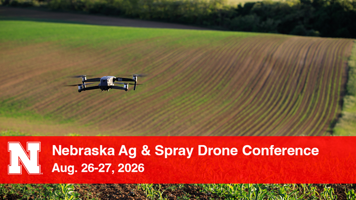Drone flying over a cultivated field with conference text overlay on a red banner.
