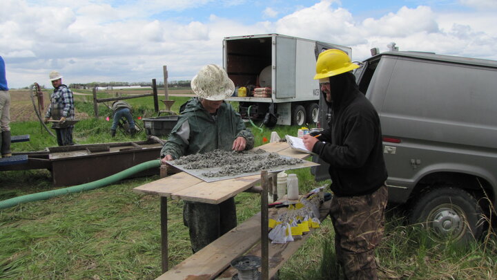 Sue Lackey, left, describes sediment samples to write on the field log and bag for further examination.
