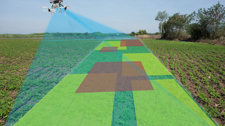  A drone equipped with sensors flies over a crop field, projecting a scanning beam that maps the field with overlaid color-coded zones indicating variations in crop health or soil conditions.
