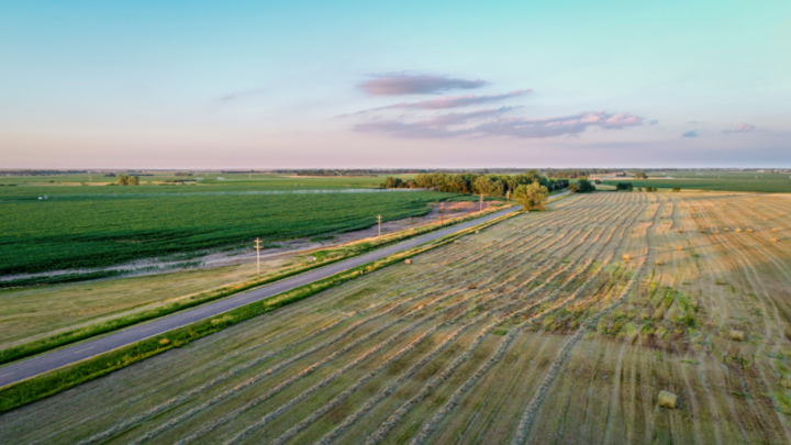 aerial photo of farmland and country road