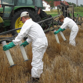 Two workers filling pesticide containers