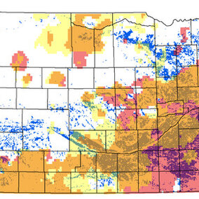 Distribution of the 1-square-kilometer cells where irrigated land in 2012 exceeded 50 percent of the cell area (blue-green dots) in Nebraska. Pink corresponds to declining annual, while yellow corresponds to declining irrigation-season (May-July) precipitation rates over the 1979-2015 period. The brownish color marks their spatial overlap.