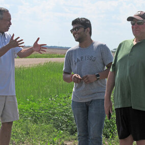 Rezaul Mahmood (left), co-leader of the GRAINEX project, talks with a student and co-leader Eric Rappin (right) of Western Kentucky University.