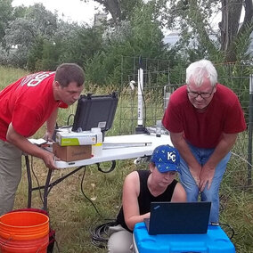 Aaron Mittelstet, Troy Gilmore, Mikaela Cherry and Didier Gatsmana sampling groundwater