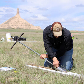 Riley Hackbart using soil probe