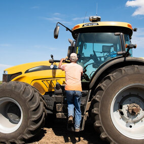 Farmer entering tractor