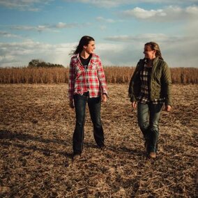 Women farmers talking in field