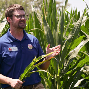 Nathan Mueller speaking in corn field 