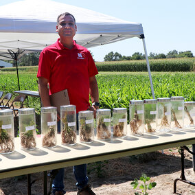 Vesh Raj Thapa stands near soil sample display