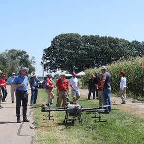 Field day participants inspect an ag drone