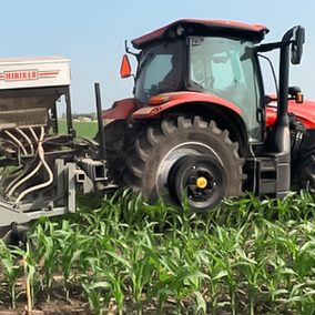 Tractor with seeder in field