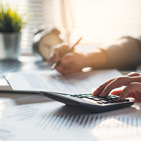 Man using calculator at desk