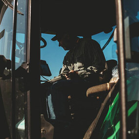 Farmer inside of tractor cab