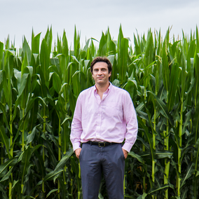 Patricio Grassini in front of corn field