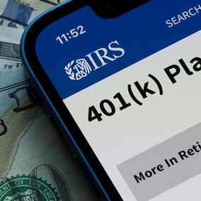 Phone displaying IRS website and cash money