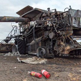 Burned farm implement in field