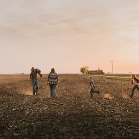 Farm family walking in field