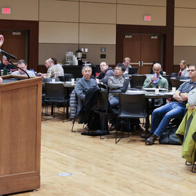 Robert Swap speaks at podium