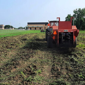 Tractor applying biochar to field