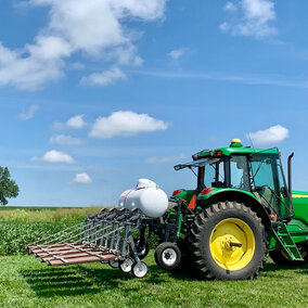 Tractor with flame weeding equipment attached