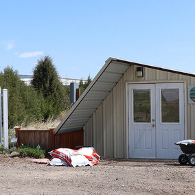 Greenhouse with signage in foreground