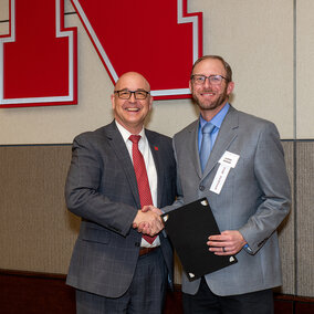 Mike Boehm and Aaron Berger shaking hands