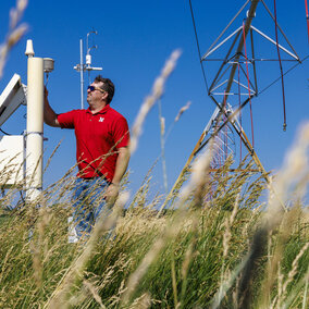 Man stands near equipment in field