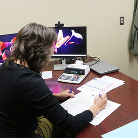 Woman works on taxes at desk