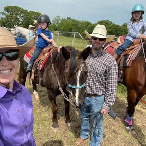 Family poses with horses