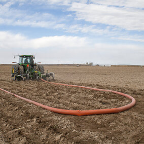 Tractor applies manure fertilizer to field