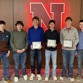 youth corn challenge winning team poses with award