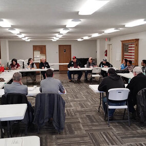 Meeting participants seated in a U-shaped table arrangement during the Shell Creek Watershed workshop, discussing conservation successes and future research needs
